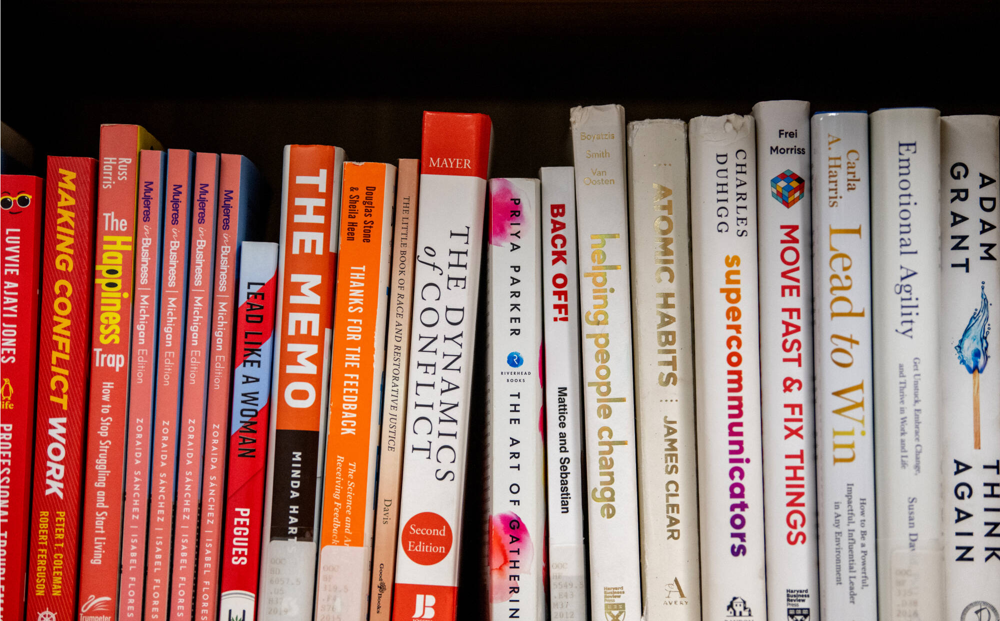 A picture of red and white books on a bookshelf in the Employee Ombuds office